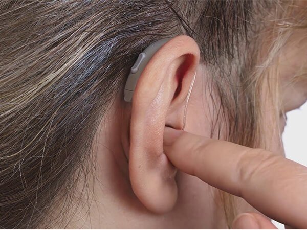 Modern receiver-in-the-ear hearing aid fitted at Prism Hearing, Pune